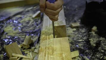 Carpenter using chisel tool for wood working. Media. Carpentry, craftsmanship, handicrafts concept. photo