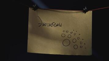 Notes with red thread. Stock footage. Close-up of mysterious notes connected by red thread. Symbols and puzzles on mysterious board with threads photo