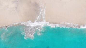Tropical beach with turquoise ocean water and waves, aerial view. Top view of paradise island video