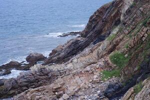 Cliffs and waves by the seaside photo