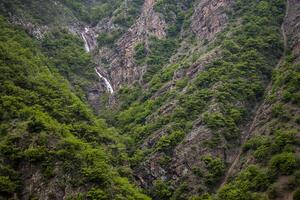 A beautiful waterfall in the heart of the mountain photo
