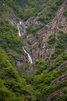 A beautiful waterfall in the heart of the mountain photo