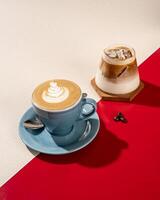 A cup of cold latte coffee and hot latte coffee on a red and white background photo