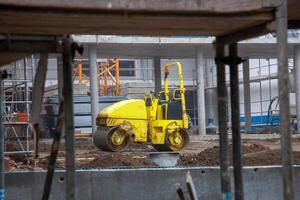 Powerful construction compactor at work, shaping the foundation with precision. Essential equipment for building projects. photo