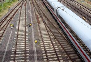 Multiple railroad tracks with junctions at a railway station in a perspective and birds view photo