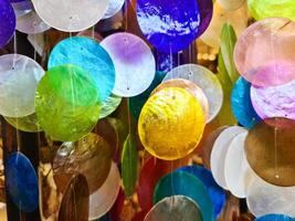 Close-up of a colorful glass wind chime with many colors. photo