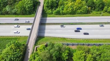 Drone view of a highway in Germany with a lot of traffic and many green fields around it. photo