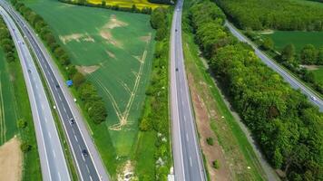 Drone view of a highway in Germany with a lot of traffic and many green fields around it. photo