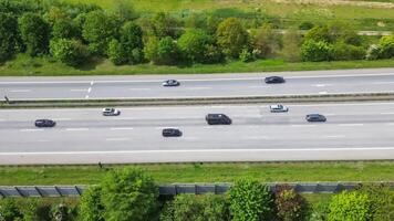 Drone view of a highway in Germany with a lot of traffic and many green fields around it. photo