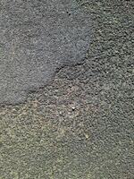 View of road asphalt with many cracks and potholes in urgent need of repair. photo