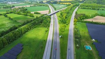 Drone view of a highway in Germany with a lot of traffic and many green fields around it. photo
