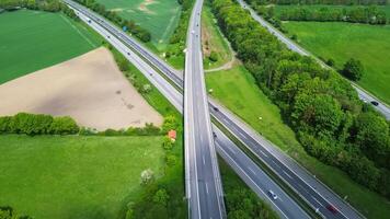 Drone view of a highway in Germany with a lot of traffic and many green fields around it. photo