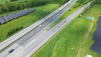 Drone view of a highway in Germany with a lot of traffic and many green fields around it. photo