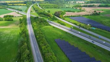 Drone view of a highway in Germany with a lot of traffic and many green fields around it. photo