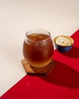 ced lemon tea is a tea drink served cold with ice cubes and lemon. photo