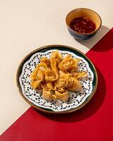 Mini Dumplings are a traditional Chinese food in the form of minced meat wrapped in a sheet of fried wheat flour photo