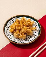 Mini Dumplings are a traditional Chinese food in the form of minced meat wrapped in a sheet of fried wheat flour photo