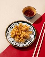 Mini Dumplings are a traditional Chinese food in the form of minced meat wrapped in a sheet of fried wheat flour photo