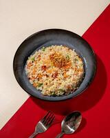 Fried rice is a dish of rice fried in a pan which produces a different taste because it is mixed with spices such as certain spices and sweet soy sauce. photo