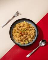 Beef fried rice is a dish of rice fried in a pan which produces a different taste because it is mixed with spices and beef. photo