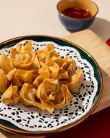 Mini Dumplings are a traditional Chinese food in the form of minced meat wrapped in a sheet of fried wheat flour photo