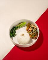 Beefsteak is processed chicken that goes through a grilling process until the meat is cooked inside and out, served with warm sauce and rice photo