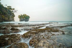 seascape is very beautiful with coral rocks and sea water that looks very soft like cotton. slow shutter speed effect photo