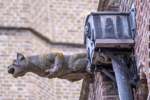 stone gargoyle on an old church photo