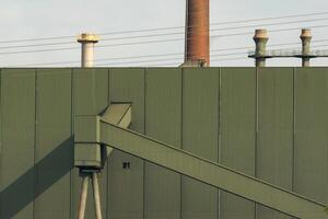 detailed view of an industrial building with high voltage power lines photo