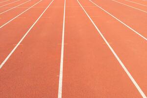 Synthetic track with white lines in the athletics stadium photo