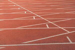 Synthetic track with white lines in the athletics stadium photo