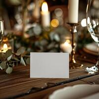 Elegant table setting with candles, glassware, and a blank place card for weddings or special events, warm and inviting ambiance. photo