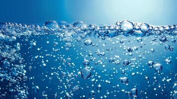 Sparkling water bubbles rising, set against a deep blue, leaving top section clear for copy photo