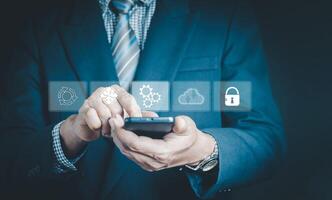Software update or operating system upgrades to keep your device up to date with enhanced functionality in new versions and improved security. Man using smartphone to install software update. photo