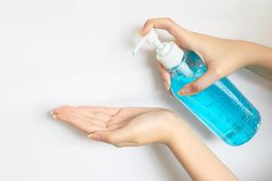 Cropped shot view of woman washing hand by hand sanitizer. photo