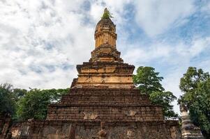 Ancient pagoda in Wat Chedi Jet Thaew the largest temple compound in Si Satchanalai Historical Park of Sukhothai province of Thailand. This temple consists of 32 chedis in various style. photo