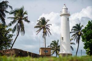 Galle Lighthouse in Galle fort or Dutch Fort one of UNESCO world heritage site in southwest coast of Sri Lanka. Lighthouse are to serve as a navigational aid and to warn boats of dangerous areas. photo
