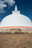 View of Ruwanwelisaya stupa in ancient city of Anuradhapura, Sri Lanka. Ruwanwelisaya stupa is one of the world's tallest ancient monuments and containing Buddha relics. photo