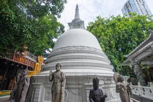 The white pagoda located in Gangaramaya temple one of the most famous temple in Colombo city, Sri Lanka. photo