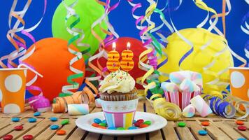 Birthday 88 cupcake with candles burning on rustic wooden table with background of colorful balloons, plastic cups and candies with blue wall in the background photo