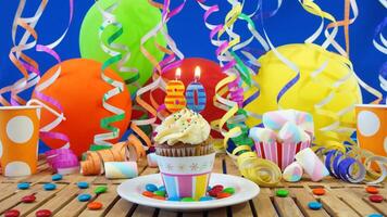 Birthday 80 cupcake with candles burning on rustic wooden table with background of colorful balloons, plastic cups and candies with blue wall in the background photo
