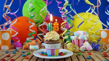 Birthday 68 cupcake with candles burning on rustic wooden table with background of colorful balloons, plastic cups and candies with blue wall in the background photo