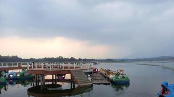 a lake with a dock and several boats in it photo