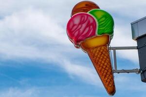 neon sign of an ice cream cone with three scoops of ice cream photo