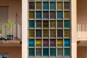 building with a balcony and a window with colorful glass photo