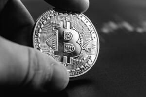 Bitcoin in hands close-up. Cryptocurrency rate. photo
