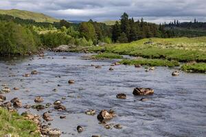View of the River Gaur in Perthshire Scotland on a cloudy spring day photo