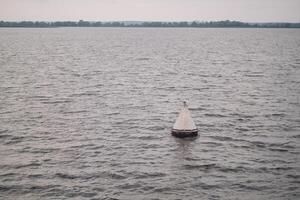buoy floating on the ocean waterline view photo