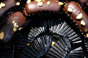 Photography of Chocolate Cookies wrapped in black paper background. Textured Detail of cookies in the jar. Graphic Resources. Food Photography. Cookies and pastries. Food Photography Concept. photo