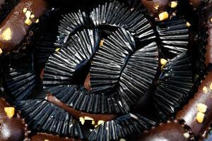 Photography of Chocolate Cookies wrapped in black paper background. Textured Detail of cookies in the jar. Graphic Resources. Food Photography. Cookies and pastries. Food Photography Concept. photo